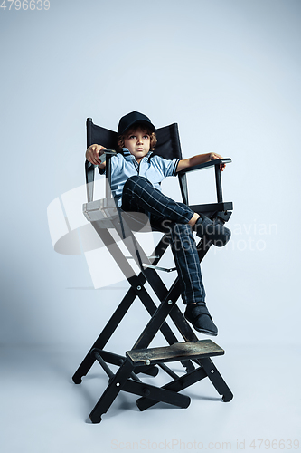 Image of Pretty young boy in casual clothes on white studio background