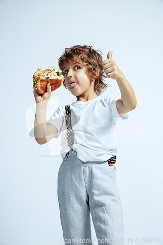 Image of Pretty young boy in casual clothes on white studio background