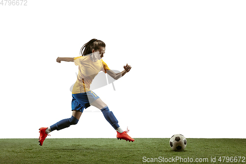 Image of Female soccer player kicking ball at the stadium