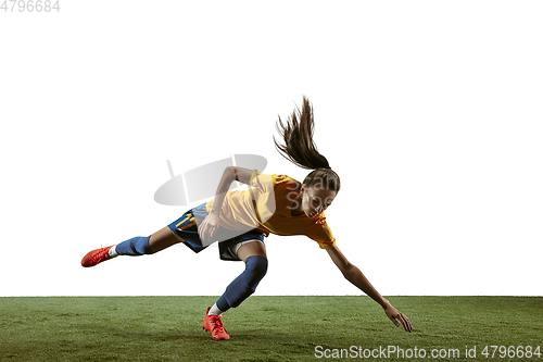 Image of Female soccer player kicking ball at the stadium