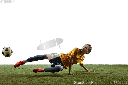 Image of Female soccer player kicking ball at the stadium