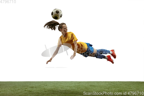 Image of Female soccer player kicking ball at the stadium