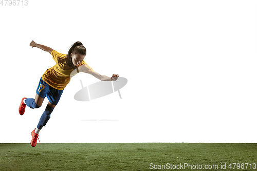 Image of Female soccer player kicking ball at the stadium