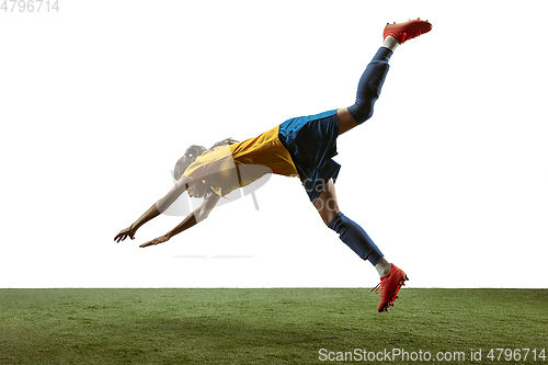 Image of Female soccer player kicking ball at the stadium