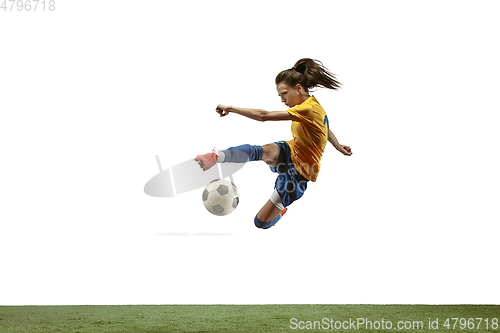 Image of Female soccer player kicking ball at the stadium