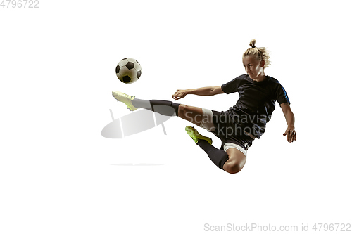 Image of Female soccer player kicking ball at the stadium