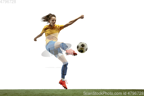 Image of Female soccer player kicking ball at the stadium