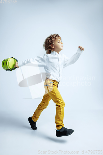 Image of Pretty young boy in casual clothes on white studio background