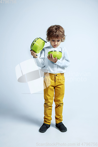 Image of Pretty young boy in casual clothes on white studio background