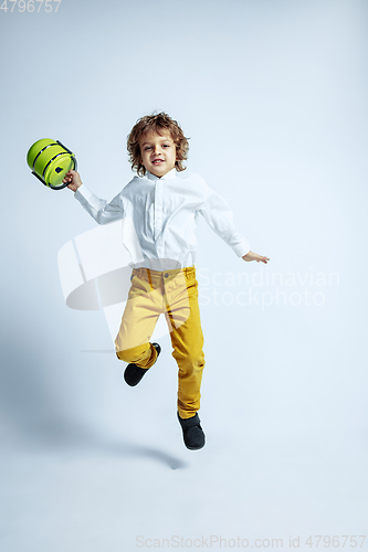 Image of Pretty young boy in casual clothes on white studio background