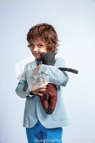 Image of Pretty young boy in casual clothes on white studio background