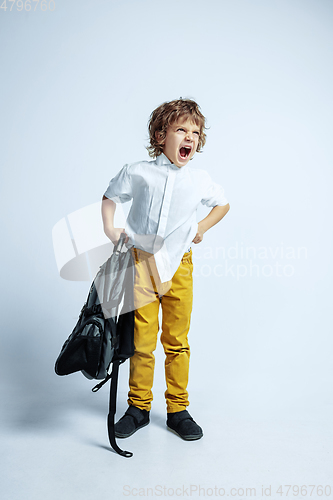 Image of Pretty young boy in casual clothes on white studio background