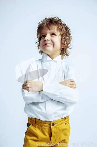 Image of Pretty young boy in casual clothes on white studio background
