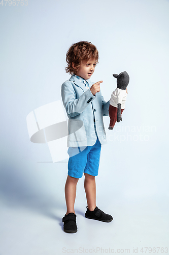 Image of Pretty young boy in casual clothes on white studio background