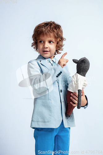 Image of Pretty young boy in casual clothes on white studio background