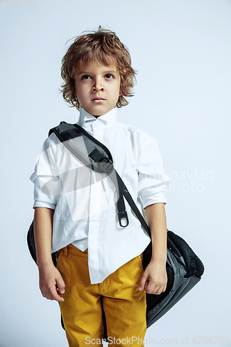 Image of Pretty young boy in casual clothes on white studio background