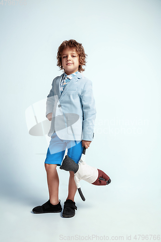 Image of Pretty young boy in casual clothes on white studio background