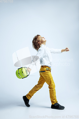 Image of Pretty young boy in casual clothes on white studio background