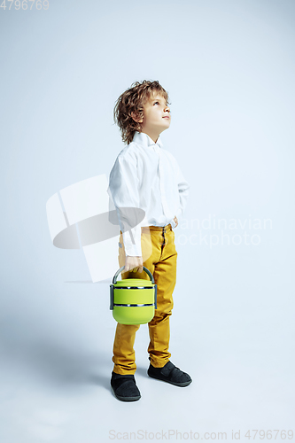 Image of Pretty young boy in casual clothes on white studio background