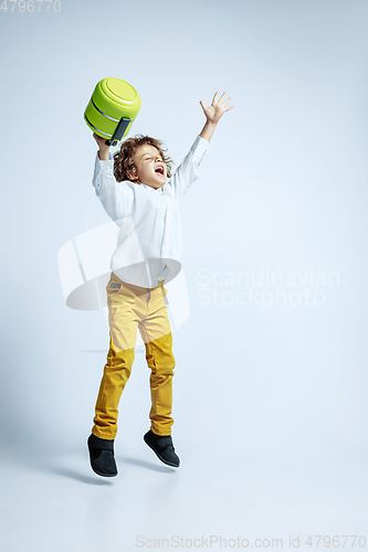 Image of Pretty young boy in casual clothes on white studio background