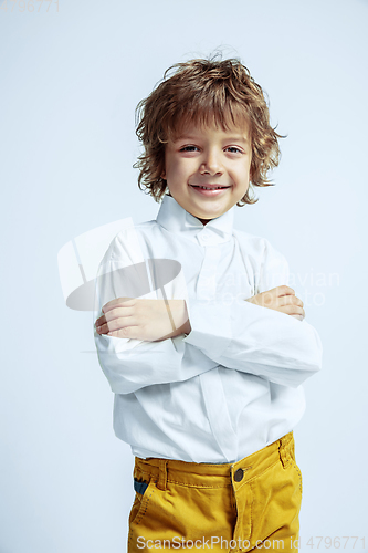 Image of Pretty young boy in casual clothes on white studio background