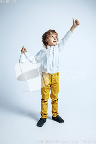 Image of Pretty young boy in casual clothes on white studio background