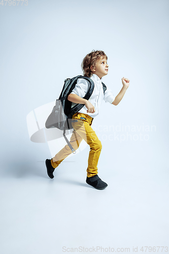 Image of Pretty young boy in casual clothes on white studio background