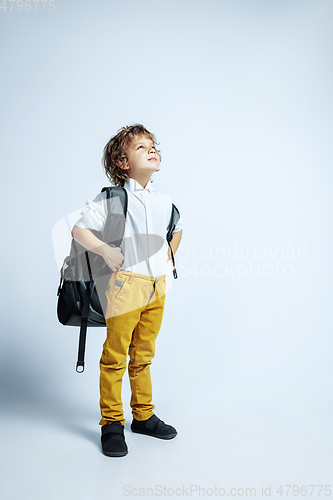 Image of Pretty young boy in casual clothes on white studio background