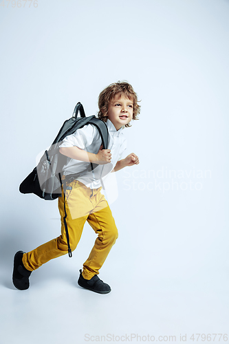 Image of Pretty young boy in casual clothes on white studio background