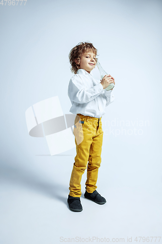 Image of Pretty young boy in casual clothes on white studio background