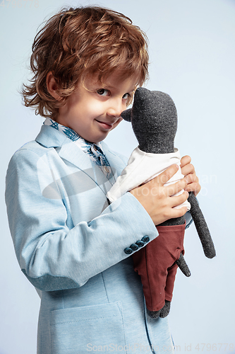 Image of Pretty young boy in casual clothes on white studio background