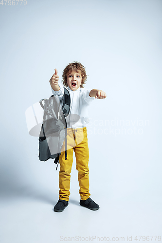 Image of Pretty young boy in casual clothes on white studio background