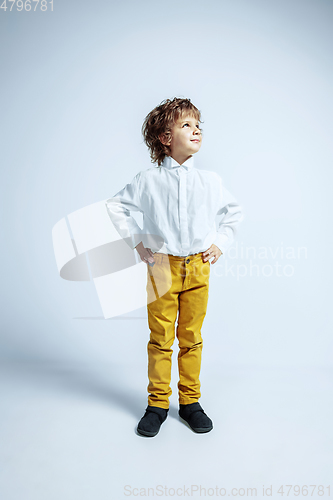 Image of Pretty young boy in casual clothes on white studio background