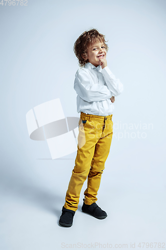 Image of Pretty young boy in casual clothes on white studio background