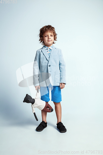 Image of Pretty young boy in casual clothes on white studio background