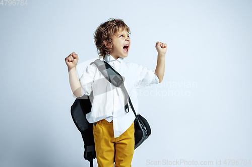 Image of Pretty young boy in casual clothes on white studio background