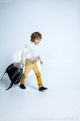 Image of Pretty young boy in casual clothes on white studio background