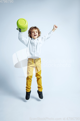 Image of Pretty young boy in casual clothes on white studio background