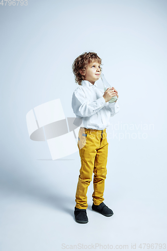 Image of Pretty young boy in casual clothes on white studio background