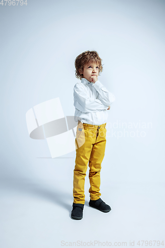 Image of Pretty young boy in casual clothes on white studio background