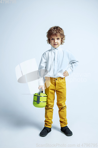 Image of Pretty young boy in casual clothes on white studio background