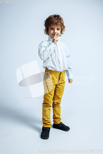 Image of Pretty young boy in casual clothes on white studio background