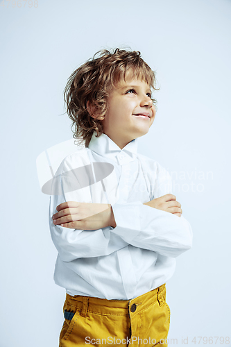 Image of Pretty young boy in casual clothes on white studio background