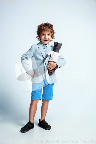 Image of Pretty young boy in casual clothes on white studio background