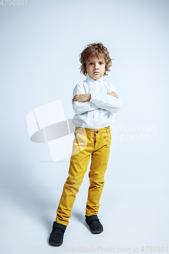 Image of Pretty young boy in casual clothes on white studio background