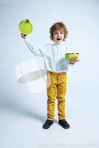 Image of Pretty young boy in casual clothes on white studio background