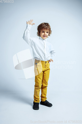 Image of Pretty young boy in casual clothes on white studio background