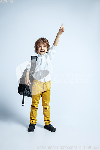 Image of Pretty young boy in casual clothes on white studio background