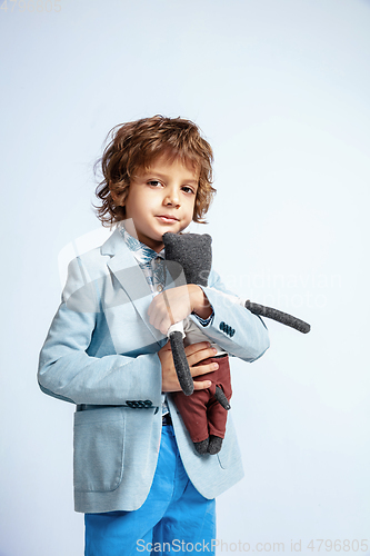 Image of Pretty young boy in casual clothes on white studio background