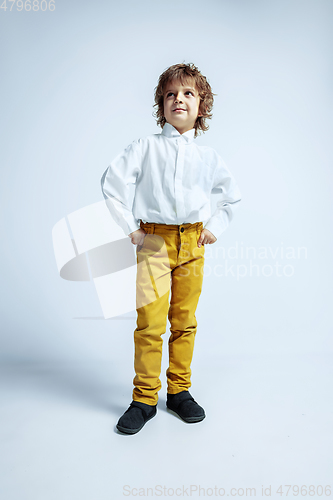 Image of Pretty young boy in casual clothes on white studio background